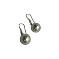 Pair of silver earrings with round pendants on a white background