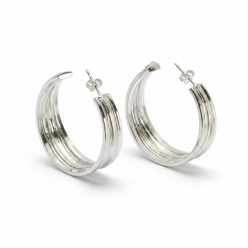 Pair of silver hoop earrings on a light gray background