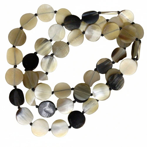 This beautiful string of small penny shaped dishes are hand threaded to form a string of beads. These can be worn long or twice around your neck, they add the warmest tones of cream thru to blacks, just a perfect touch of elegance