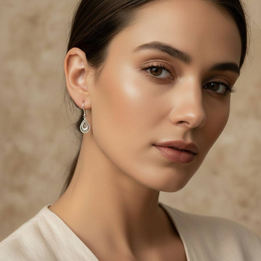 These silver teardrop dangle earrings with textured scalloped edges and fishhook wires, look so delicate.