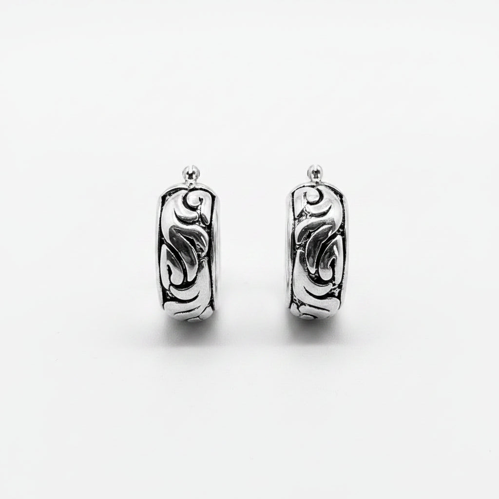 Pair of silver hoop earrings on a white background
