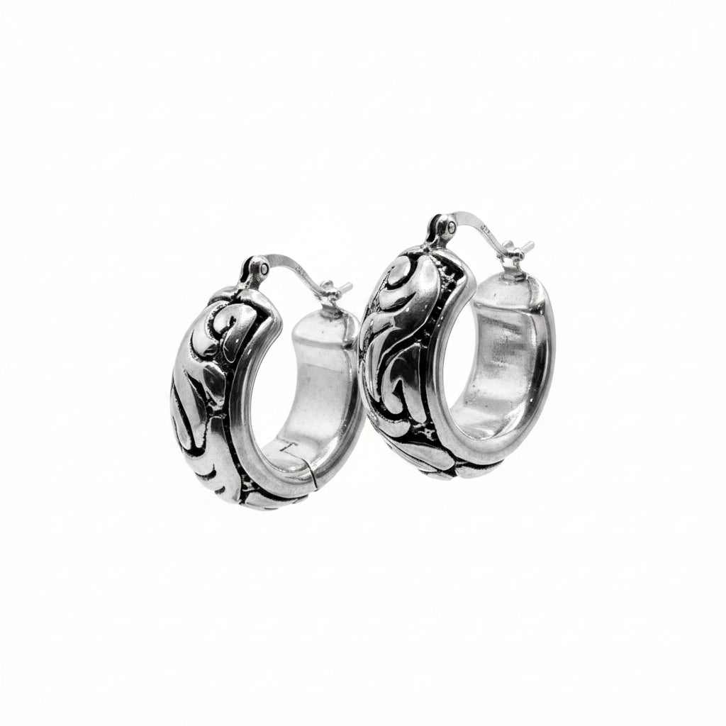 Pair of silver hoop earrings on a white background